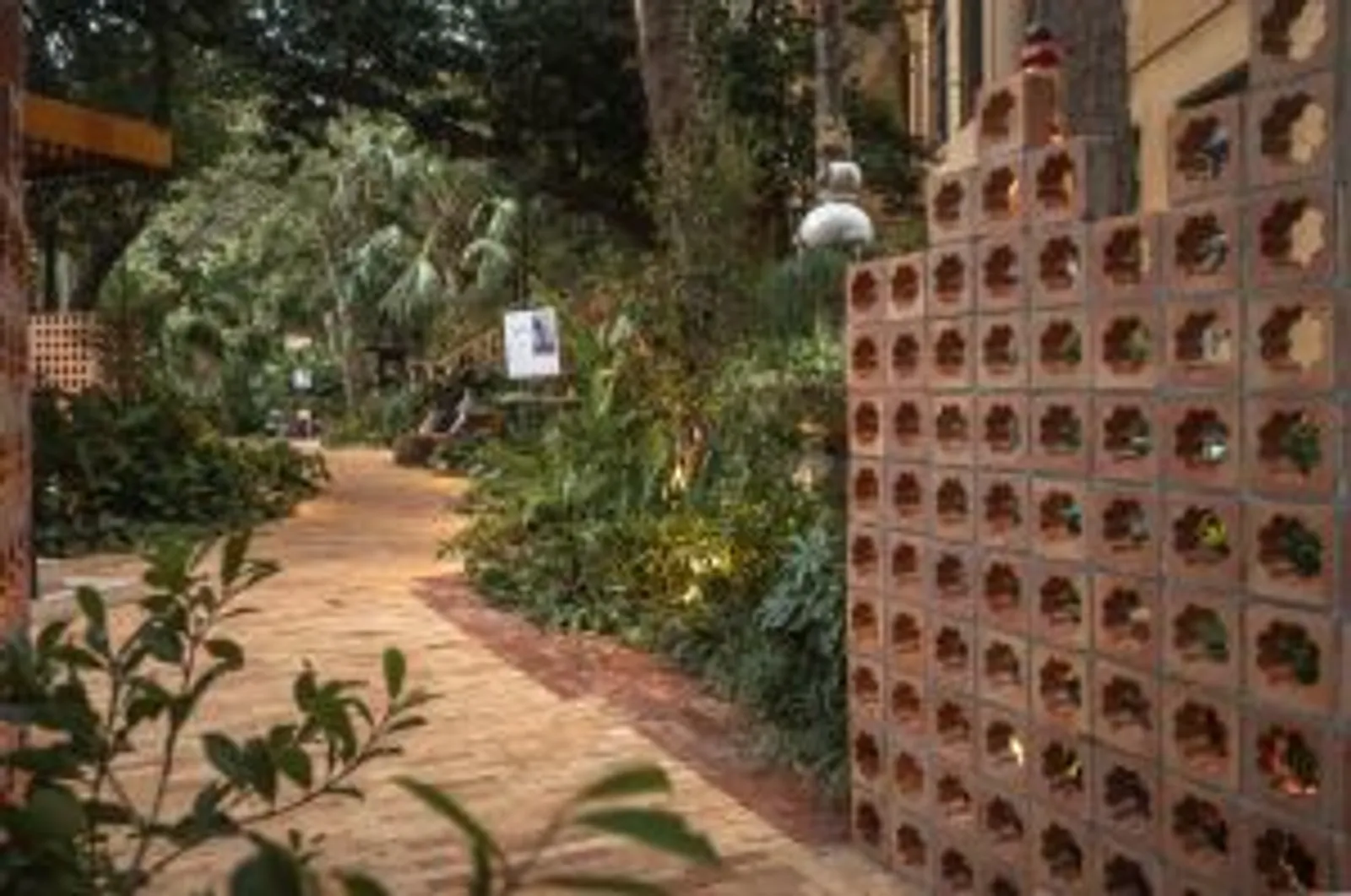 Projeto: Maria Fernanda Marques, Da terra ao solo | Vista detalhada da fachada com o paisagismo, enfatizando a integração da natureza com a arquitetura.
