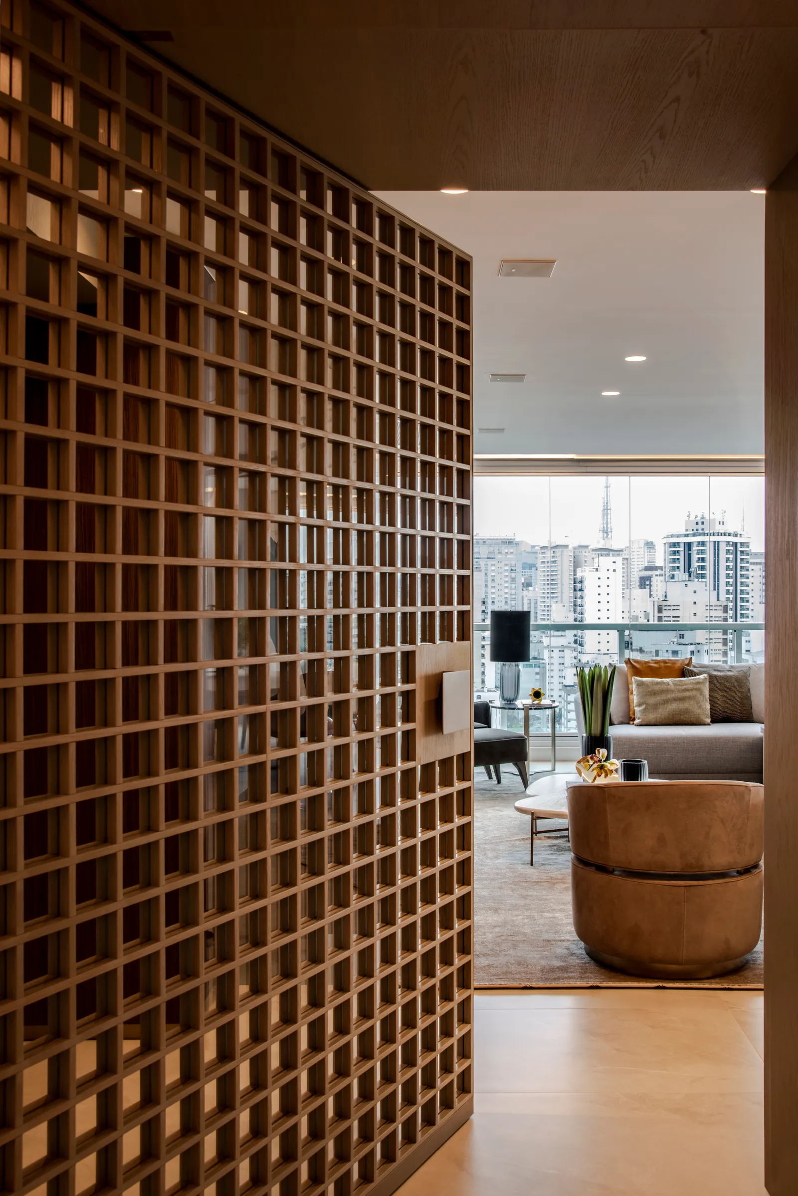 Projeto: Denise Barretto | A porta pivotante deste apartamento estabelece uma integração suave com o hall de entrada.
