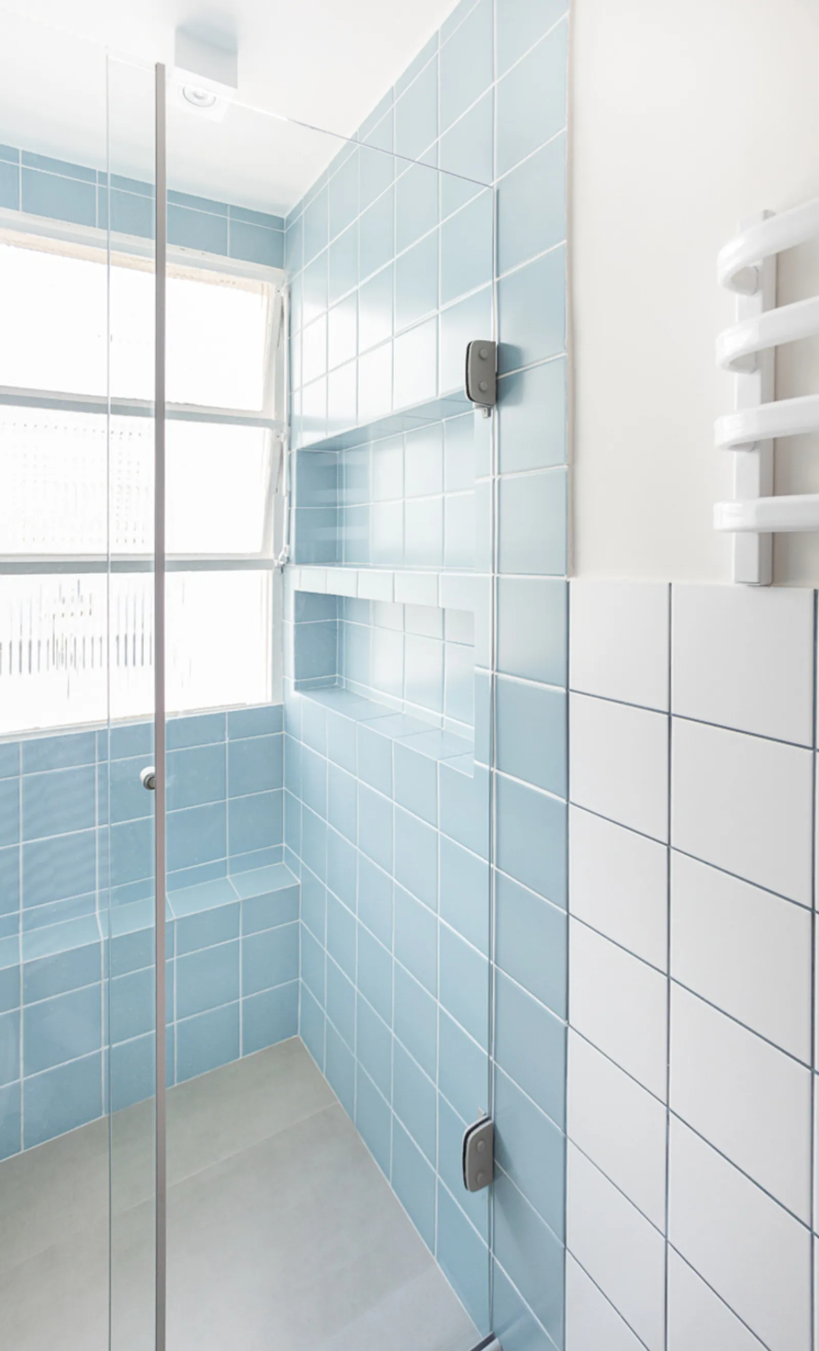 Projeto: Studio Elã | Nos banheiros, a combinação de azulejos azuis e brancos em diferentes composições cria um visual leve, atemporal e cheio de personalidade.